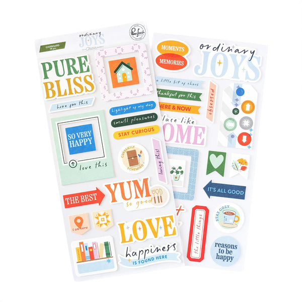 Two sheets of decorative planner stickers with colorful text and icons, including phrases like 'PURE BLISS', 'SO VERY HAPPY', 'LOVE happiness', and 'moments + memories', shown on a white background.