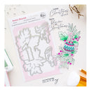 Festive Flourish stamp and die set by Product is Love Studio, featuring a 4-piece steel craft die set on a pink backing card, displayed next to a stamped Christmas illustration on a light beige background with decorative craft props.