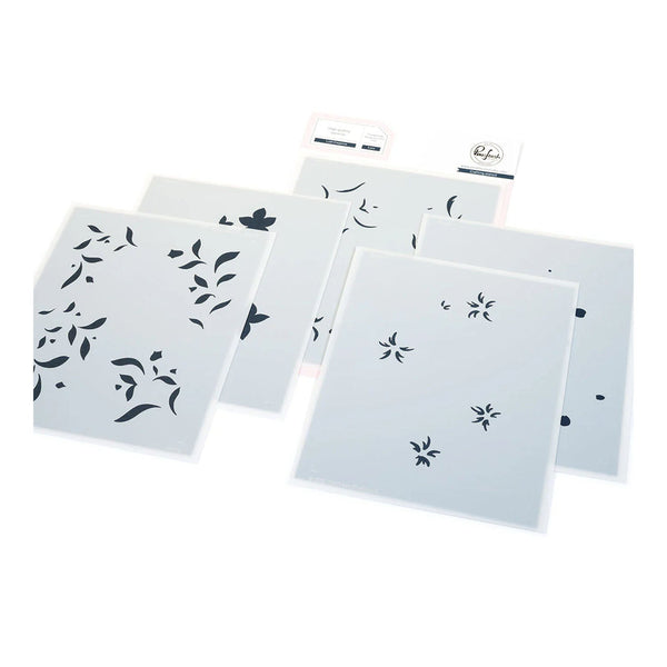 Set of white stencils with black floral patterns on a white background