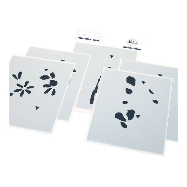 Set of four white stencils with black floral and geometric designs on a white background