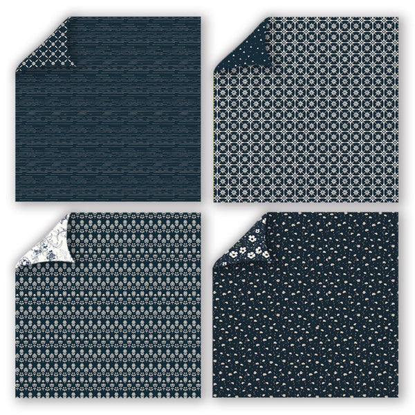 Four square fabric or paper swatches arranged in a 2x2 grid, each showing a navy and white pattern with one corner folded over to reveal the reverse side. The top-left swatch has a dark navy textured pattern, the top-right has a repeating geometric medallion pattern, the bottom-left has a small floral motif, and the bottom-right has tiny scattered dots.