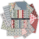 A fanned-out arrangement of patterned paper sheets with a central black label reading 'Nordic Christmas.' The papers feature multiple holiday motifs including snowflakes, trees, geometric patterns, reindeer, ornaments, and stripes in red, green, blue, cream, and gray.