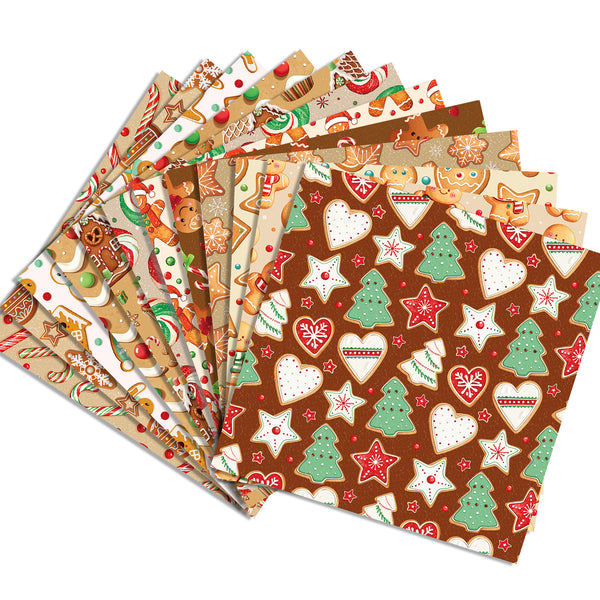 A fan of Christmas-themed patterned paper napkins or gift wrap sheets on a white background, featuring designs with gingerbread cookies, candy canes, stars, hearts, and trees in brown, beige, green, red, and white.
