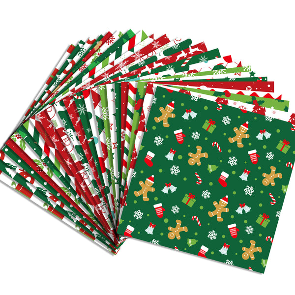 A fan arrangement of Christmas-themed wrapping paper sheets on a plain white background. The visible designs include red and green stripes, white snowflakes, gingerbread men, candy canes, stockings, and gift boxes on a dark green base.