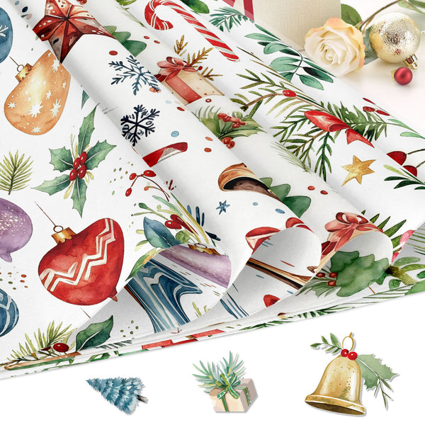 A stack of rolled Christmas-themed wrapping paper sheets with a festive watercolor print featuring red ornaments, green holly leaves, pine branches, snowflakes, candy canes, and gift boxes on a white background. Small decorative holiday props are arranged around the paper.