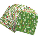 A fan of Christmas-themed wrapping paper sheets on a plain white background. The papers feature various holiday patterns including pine trees, candy canes, ornaments, and snowflakes in green, white, and red.