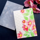 Floral embossing folder with pink flowers and green leaves on a dark background