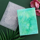 Two embossed cardstocks with floral patterns on a green background with flowers.