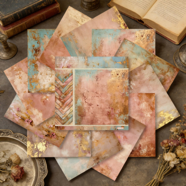 Collection of vintage-style stationery items on a textured surface with books and dried flowers.