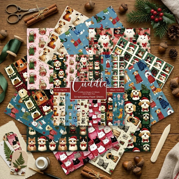 A flat lay of multiple Christmas-themed paper craft sheets featuring cute dog illustrations in winter outfits, arranged on a wooden surface with crafting props like scissors, twine, green ribbon, pinecones, and a wooden spatula. A central label reads 'Cuddle' and '12 Different Designs 2.