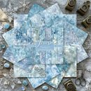 Collection of blue marbled paper sheets with decorative elements on a wooden surface.