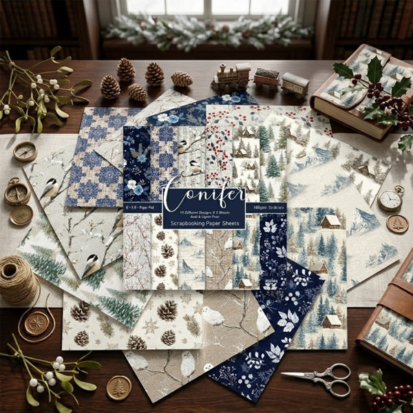 A styled flat-lay of Conifer paper sheets arranged on a wooden table with winter-themed props including pinecones, twine, scissors, books, and holly. The sheets feature blue, beige, and white winter patterns such as snowflakes, trees, birds, and snowy landscapes.