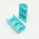 A light blue silicone mold set consisting of a rectangular base with triangular star-shaped indentations and a matching curved cover piece, shown on a plain white background.