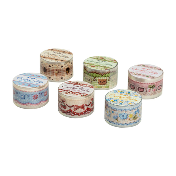 Set of small decorative tins with patterned lids on a white background