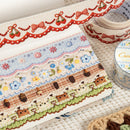 Collection of decorative tape rolls with various patterns on a textured surface.