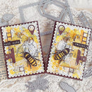 Two handmade cards with bee designs and metal dies on a textured surface.