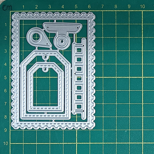 Set of metal cutting dies on a green grid background