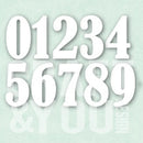 White die-cut numbers 0 through 9 in a bold serif font, arranged in two rows on a pale mint green background with a faint watermark.