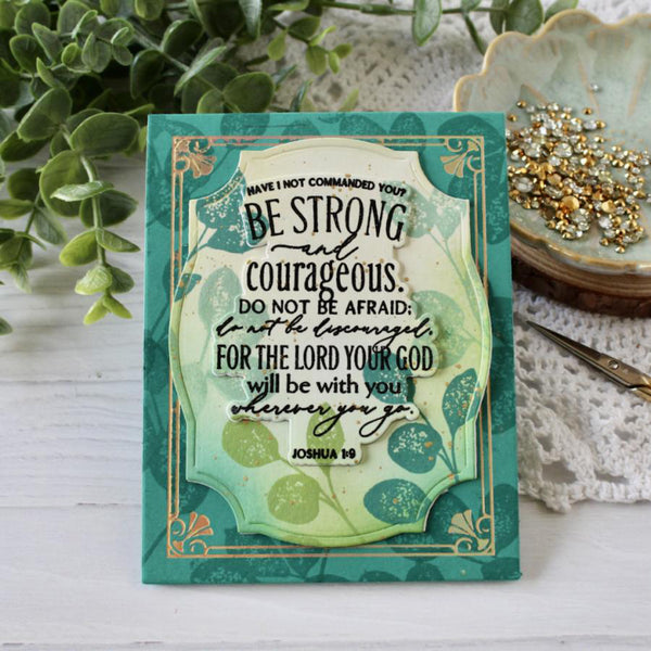 Decorative card with motivational quote on a wooden surface with plants and jewelry in the background