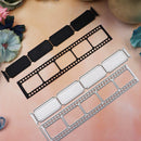Three metal die-cut craft templates shaped like vintage film reels are arranged on a soft peach background with decorative flowers in the corners. One template is black, and two are silver-colored metal.