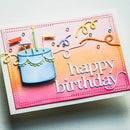 A handmade square birthday card featuring a colorful gradient background that fades from pink to orange to yellow. The card is decorated with a 3D blue birthday cake, lit candles, ribbon-like swirls, and the words 'happy birthday' in white script.