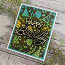 A handmade square birthday card with a green and black patterned background, featuring the words 'HAPPY Birthday' in layered black and gold glittery lettering. The card is styled on a rustic gray wooden surface with green sprigs.