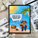 A handcrafted pirate-themed greeting card featuring a cartoon bear pirate on a tropical beach with a treasure chest and a speech bubble reading, 'IF RUM CAN'T FIX IT YOU'RE NOT USING ENOUGH RUM!' The card is displayed on a neutral surface with craft supplies, including clear stamp sheets and white flowers.