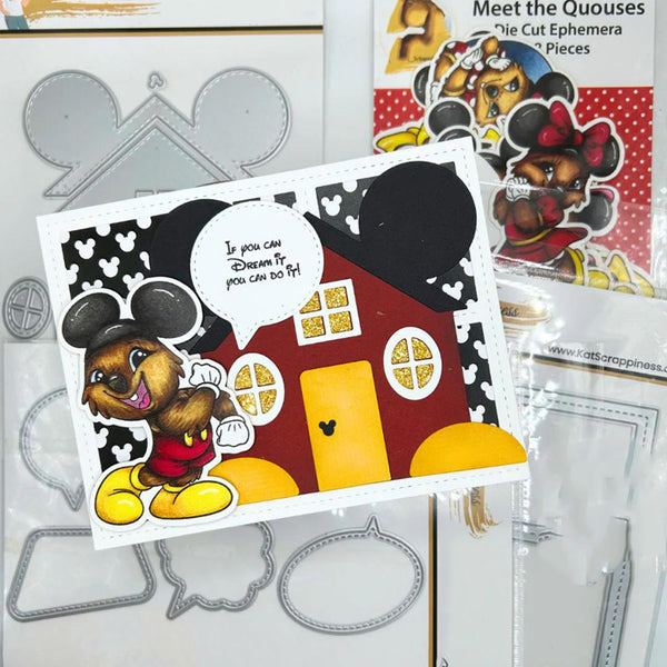 A handmade craft card featuring a cartoon mouse character in a house, shown alongside metal die-cutting and scoring tools and a package of 'Meet the Quoses' ephemeris pieces by Kats and Creations.