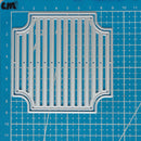 A silver metal die-cutting or stamping template with a decorative arched border and vertical slotted center, shown on a blue grid cutting mat.