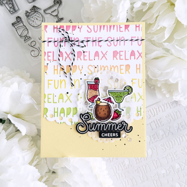 A square handmade greeting card with a summer cocktail theme, styled on a white floral background. The card features a pale yellow base with pink, orange, and green retro text reading 'HAPPY SUMMER' and 'RELAX', decorated with illustrations of a pink margarita, a green margarita, a coconut drink, and strawberries.