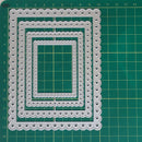 A set of five nested rectangular die-cut frames with scalloped edges and small circular cutouts, displayed on a green cutting mat with grid lines.