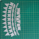 A set of white metal paper cutters shaped like bunting flags and banners, laid out on a green cutting mat with grid lines.