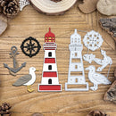 A set of nautical-themed metal cutters or decals arranged on a wooden surface, including a red-and-white lighthouse, a white lighthouse outline, an anchor, a seagull, a black compass rose, and a white nautical wheel, with pinecones and wood slices around the edges.