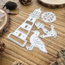 A set of white metal die-cut craft pieces featuring a lighthouse, a bird, an anchor, and a compass rose, displayed on a rustic wooden surface with pinecones and wood slices.