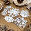 Five white metal die-cut craft shapes, including a seahorse, octopus, fish school, and coral branches, arranged on a rustic wooden surface with pinecones and wood slices.