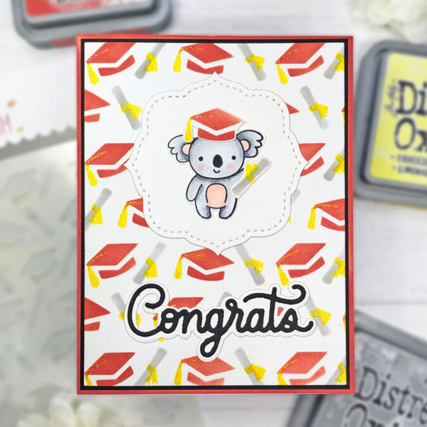 A handmade congratulations card featuring a cute cartoon koala wearing a graduation cap, surrounded by a pattern of red graduation caps and yellow diplomas on a white background. The card has a red border and the word 'Congrats' written in black script at the bottom.