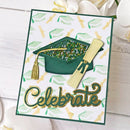 A square graduation-themed card featuring a dark green graduation cap with a gold tassel, a rolled diploma scroll, and the word 'Celebrate' in metallic gold script. The card has a white background with a subtle pattern of green and gold graduation caps, set against a white wood plank surface with blurred white flowers.