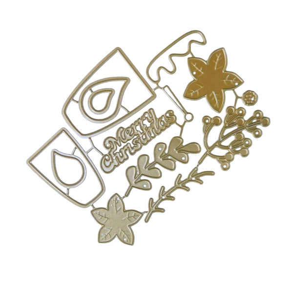 A gold-colored metal die-cut craft embellishment featuring Christmas motifs, including a 'Merry Christmas' script, a teardrop symbol, a star, and leafy sprigs, shown on a plain white background.