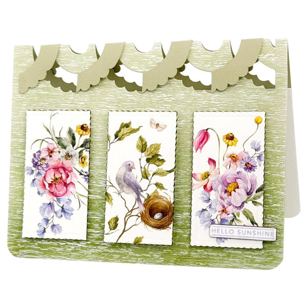 A handmade greeting card with a scalloped olive-green top border and a light green textured base. The card features three vertical floral and bird illustrations: a pink flower, a blue bird in a nest, and purple flowers with a 'HELLO SUNSHINE' banner.