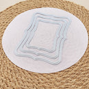 Three nested rectangular frame-shaped metal cutters with dotted borders, displayed on a round white paper disc over a woven natural fiber mat.