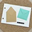 Two mini envelopes on a white card: one natural kraft brown envelope and one mint green envelope with a small heart detail, displayed on a woven jute mat.