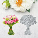 A floral bouquet stamp or die shown beside a painted bouquet of pink tulips and white flowers on a light textured background.