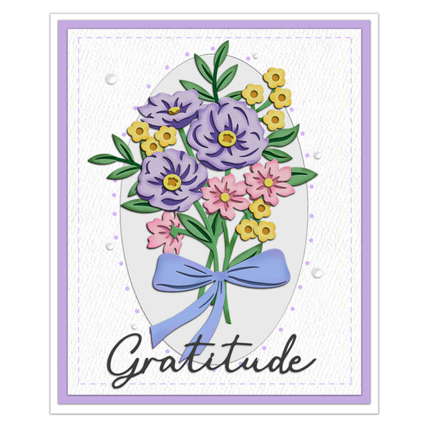 A square greeting card design with a floral bouquet illustration in purple, pink, yellow, and green, a light blue ribbon bow, the word 'Gratitude' in black script, and a lavender border on a white background.