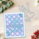 A handmade layered card with the phrase 'best day ever' in light blue script over a lavender and light purple diamond lattice pattern, shown on a light wood background alongside a silver metal die cut design.