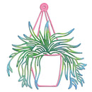A decorative metal wall hanging featuring a pink pot and hanger frame with a green and blue gradient leafy plant silhouette, shown on a plain white background.