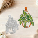 Metal cutting dies shaped like hanging plants on a wooden surface with flowers.