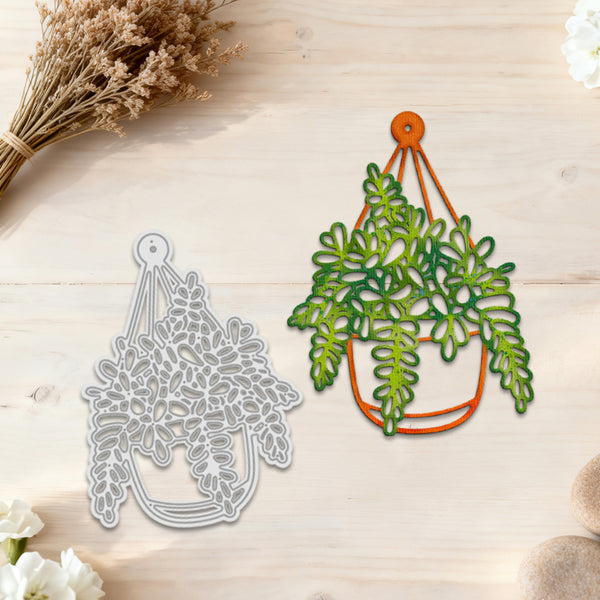 Metal cutting dies shaped like hanging plants on a wooden surface with flowers.