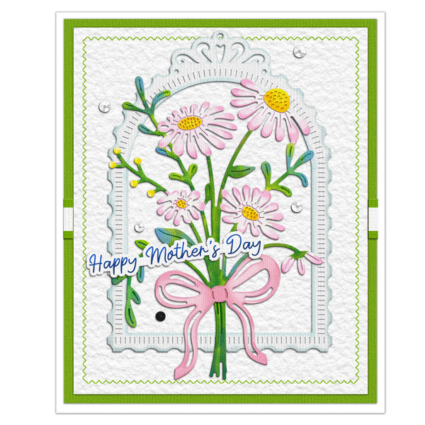 A handmade Mother's Day greeting card featuring a bouquet of pink daisies with yellow centers, green stems, and a pink ribbon, layered over a white scalloped arch. The card has a green border and the text 'Happy Mother's Day' in blue script.