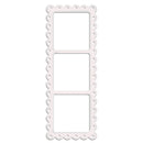 A white paper craft die or template with a scalloped border and three rectangular photo slots, shown on a plain white background.