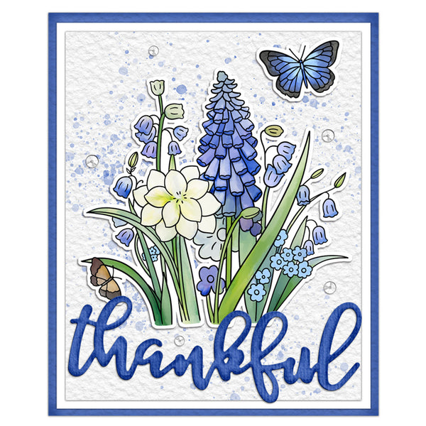 A square handmade card featuring blue and white wildflowers, a blue butterfly, and the word 'thankful' in blue script at the bottom, set against a white background with a blue border.
